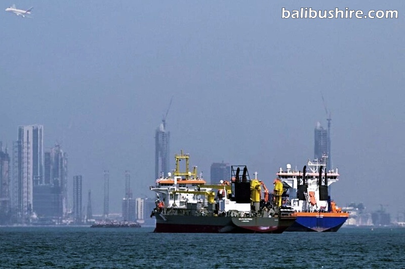 Commercial vessels are pictured offshore in Dubai on Wednesday. The Strait of Hormuz is bordered by Iran
